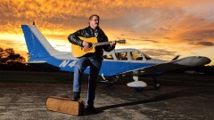 joe-martin-musician-guitar-plane-airport